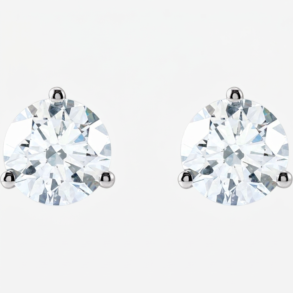 White-gold diamond studs front view on a pale near-white background