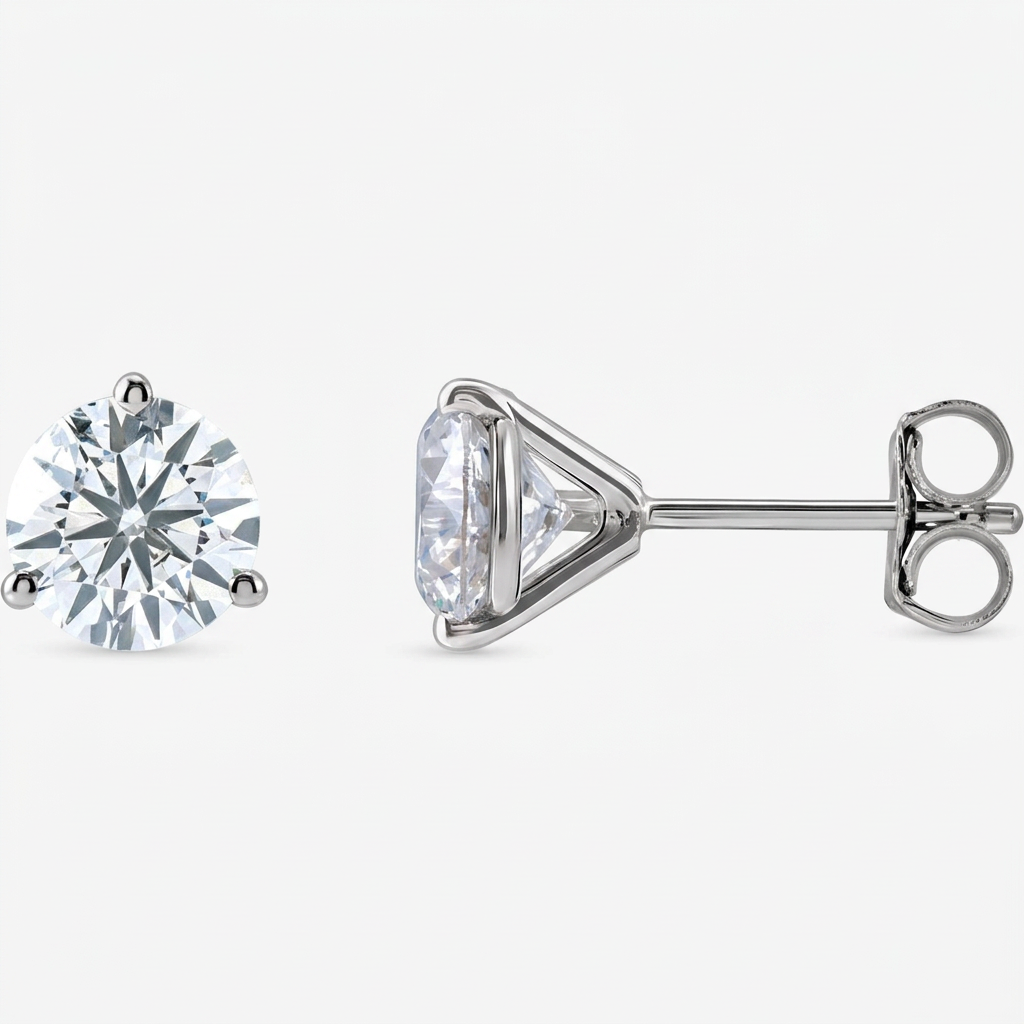 Round diamond martini-set stud earrings, front and side views on a pale near-white background
